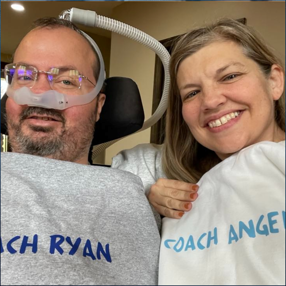 Ryan and Angela holding their Coach Ryan and Coach Angela jackets