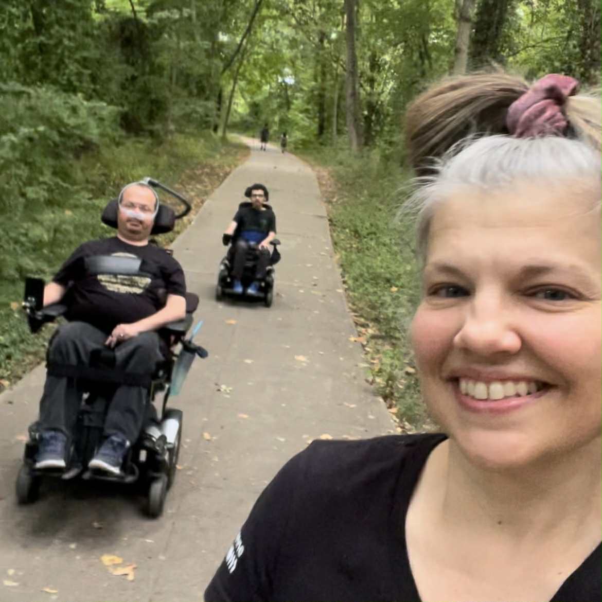 Angela with Ryan and Xavier on a wooded trail
